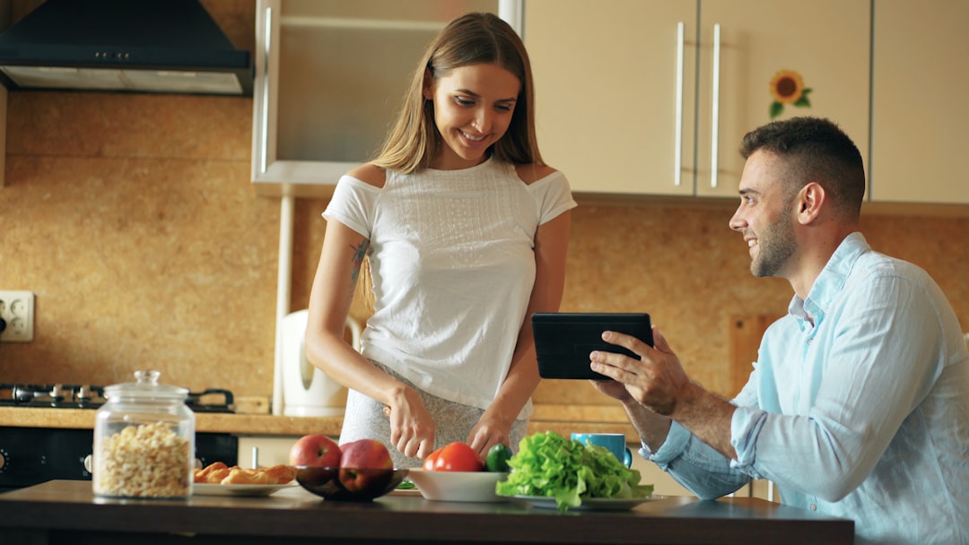 Couple preparing food together in a modern kitchen.