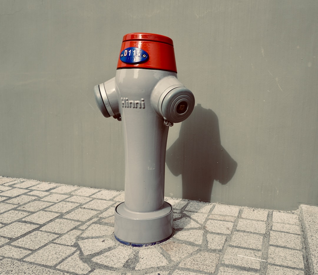 a fire hydrant is stationed on the side of a sidewalk