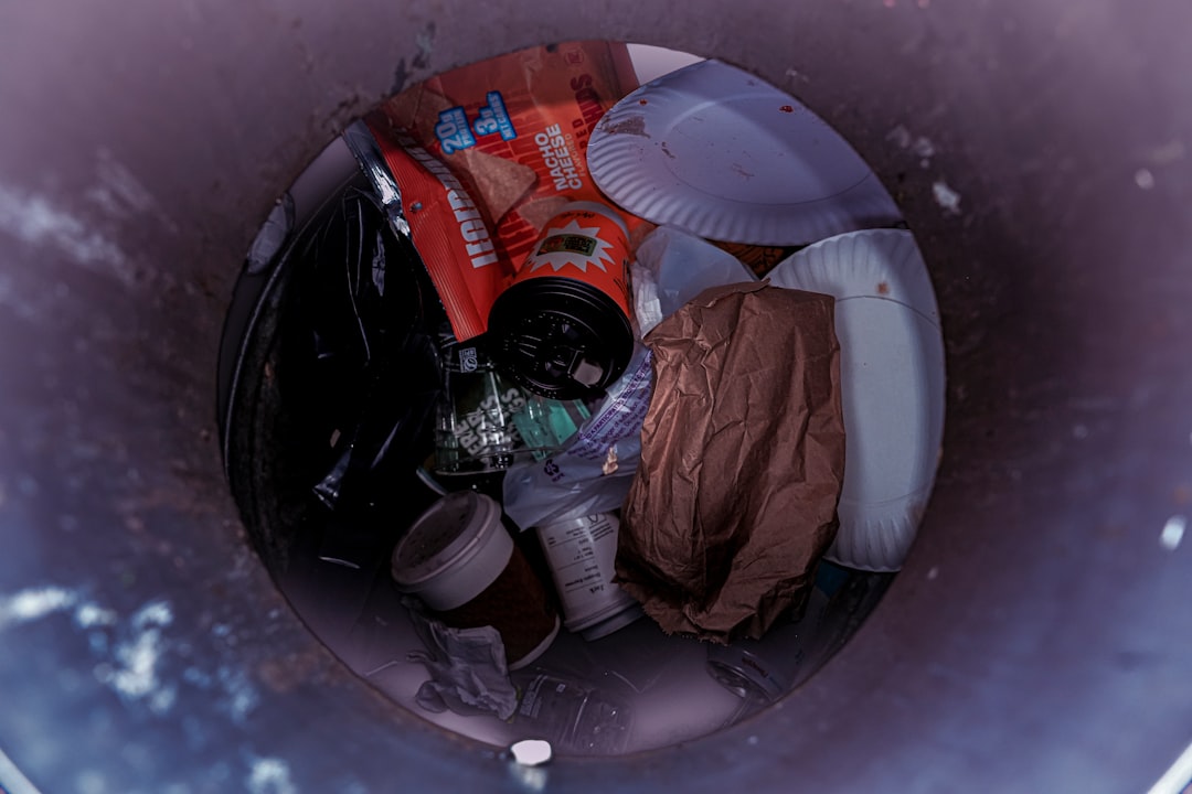 Trash can filled with various discarded items