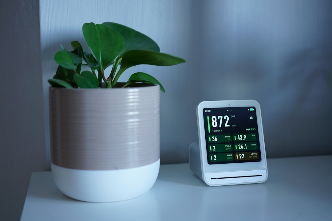 Plant next to a device displaying readings.