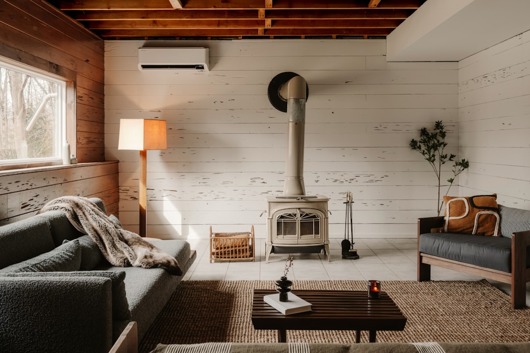 Cozy living room with wood stove and sofa.