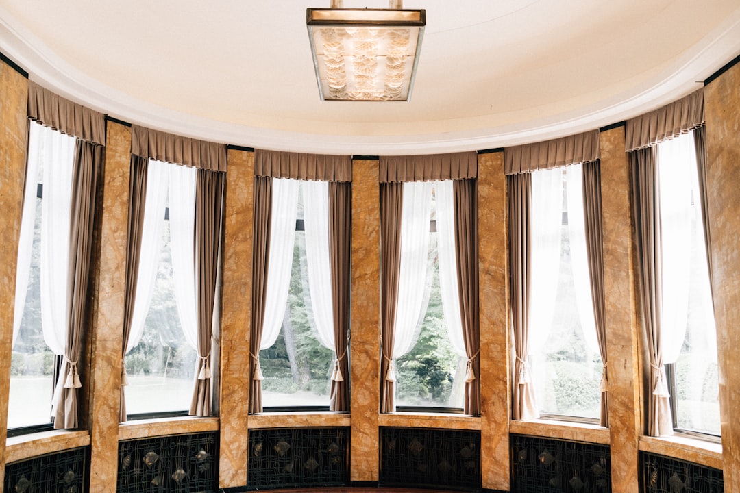 Elegant room with large windows and ornate columns