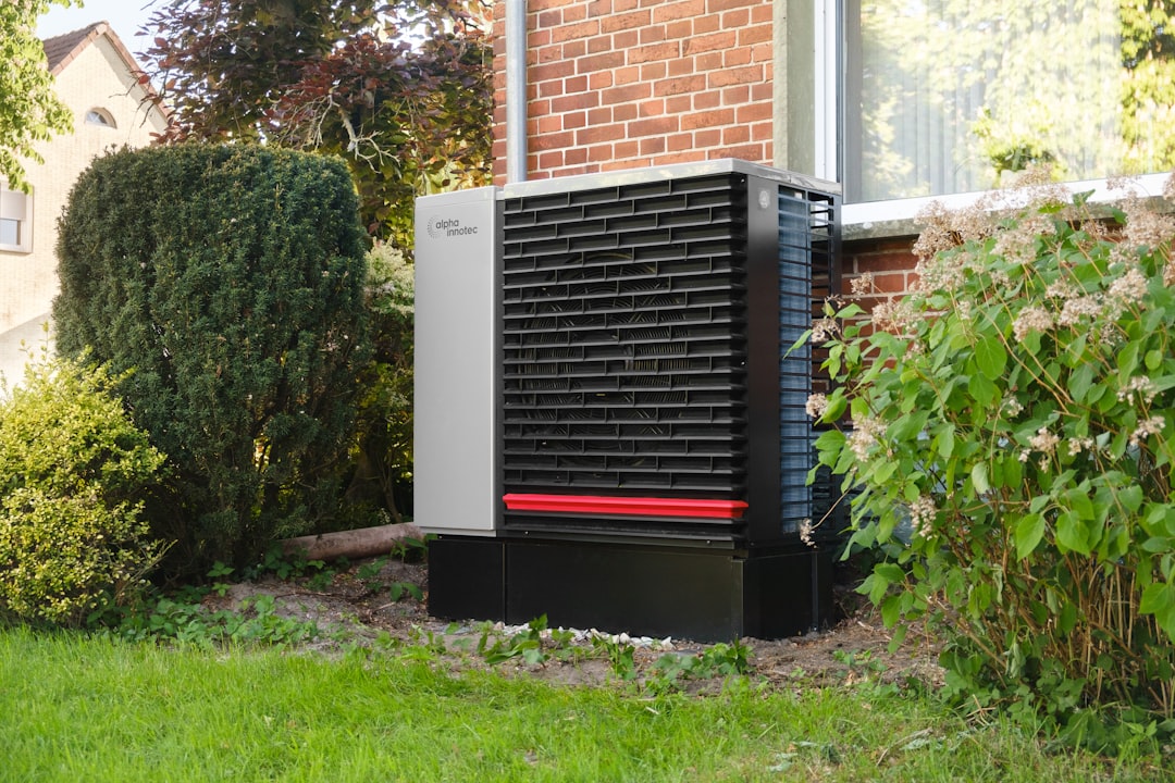 Outdoor heat pump unit next to a brick building