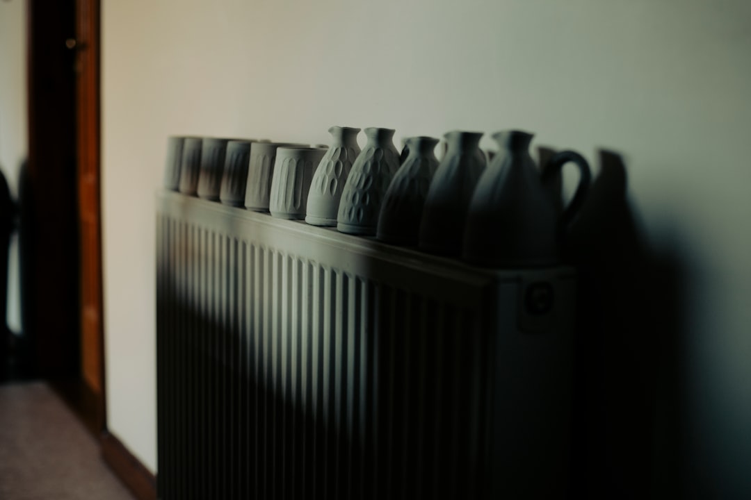Row of ceramic vases on a radiator