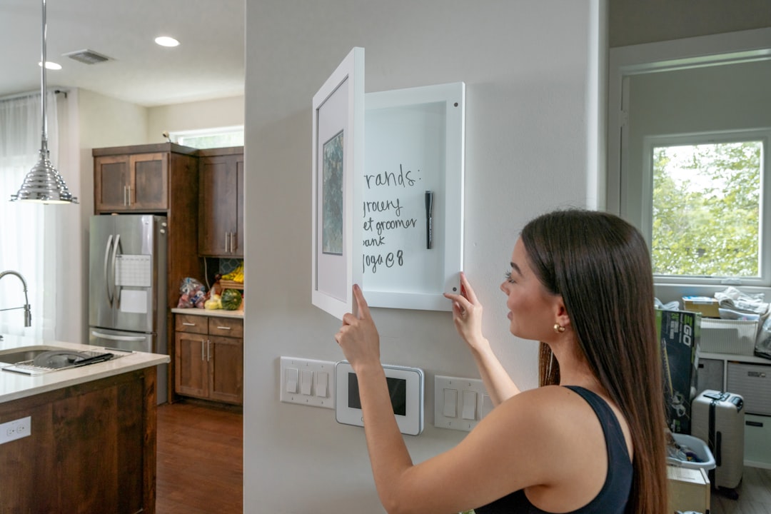 a woman is holding a magnet in a kitchen