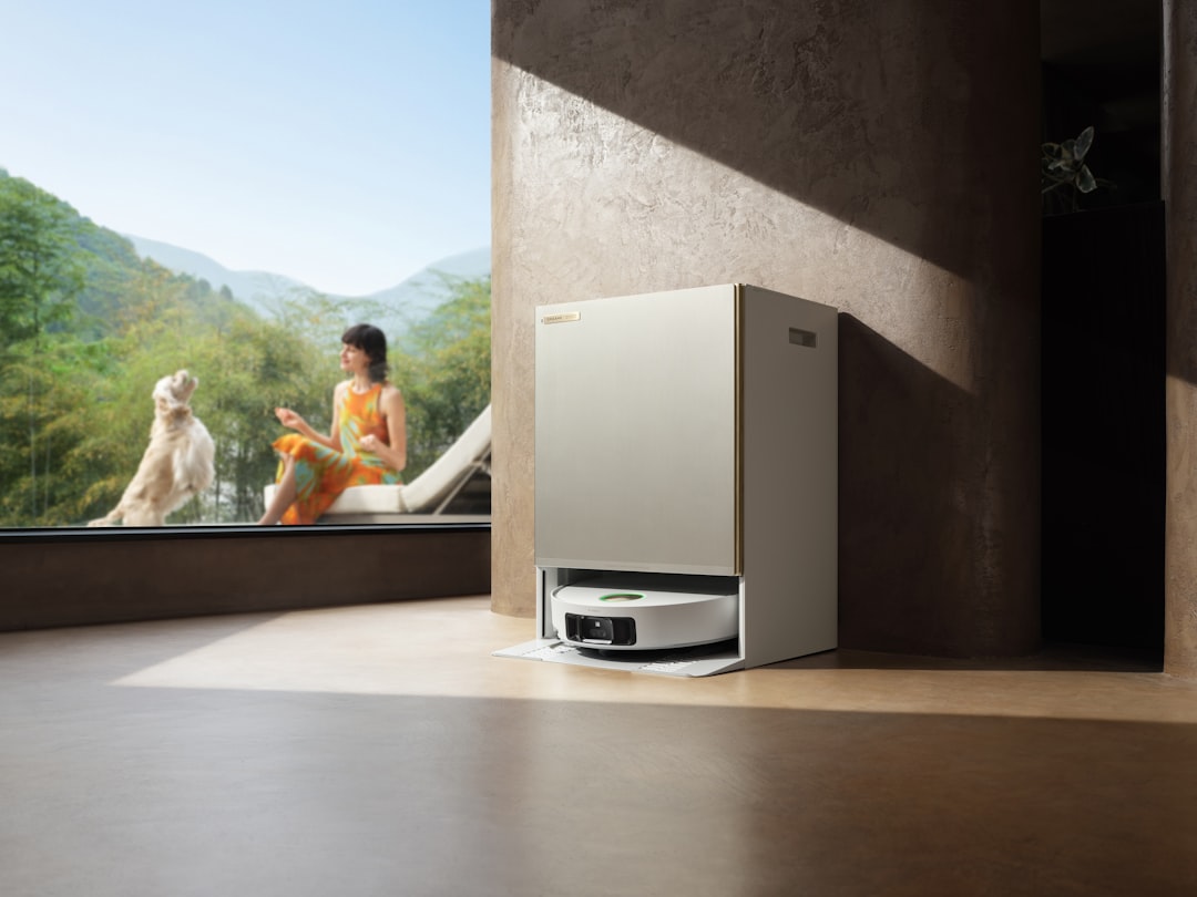 Woman and dog relax by large window with robot vacuum