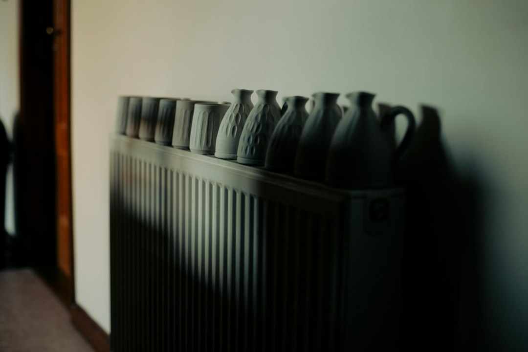 Row of ceramic vases on a radiator